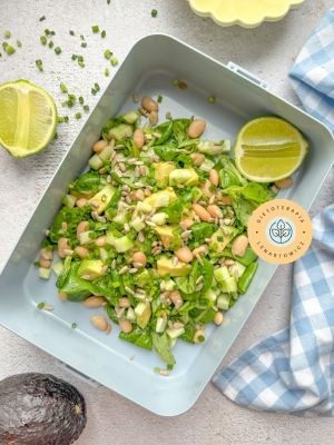 Sałatka z awokado, komosą, ogórkiem, dressingiem i dodatkami. Danie do zapakowania na wynos.